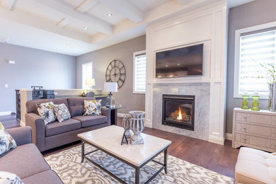 Photo of an expansive transitional formal enclosed living room in Toronto with grey walls, dark hardwood floors, a standard fireplace, a stone fireplace surround, a wall-mounted tv and brown floor.