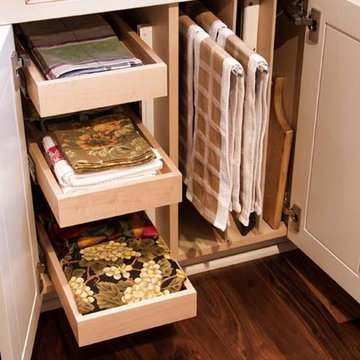 Base cabinet with rollouts, vertical storage with pull out dish towel bar