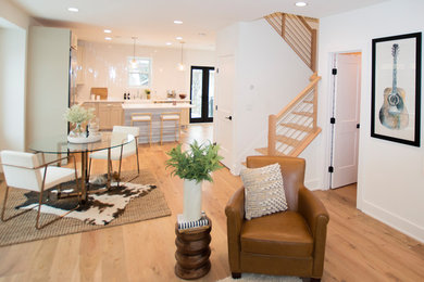 Great room - small contemporary light wood floor and beige floor great room idea in DC Metro with white walls and a standard fireplace