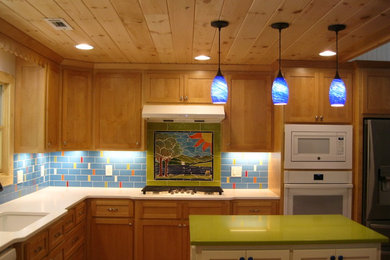 Inspiration for a craftsman u-shaped eat-in kitchen remodel in Other with a drop-in sink, shaker cabinets, quartz countertops, blue backsplash, ceramic backsplash, stainless steel appliances and an island