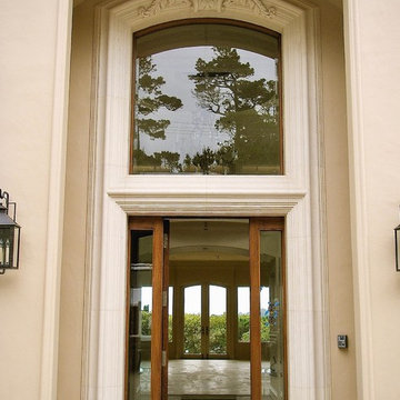 Stone door surround with an ornamented cartouche.