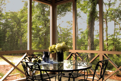 Island style front porch idea in Charleston with a roof extension