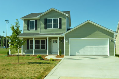 Mid-sized elegant green two-story vinyl exterior home photo in Bridgeport