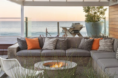Inspiration for a coastal side yard patio remodel in Los Angeles with a fire pit and a pergola