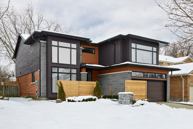 This is an example of a contemporary two-storey multi-coloured house exterior in Toronto with mixed siding, a shingle roof, a grey roof and clapboard siding.