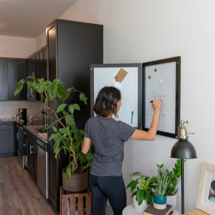 A woman planning in her organized home.
