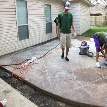 Acid stained concrete being scored