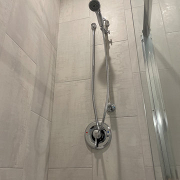 Beautiful Shower done with 12x24 porcelain tiles installed vertically.