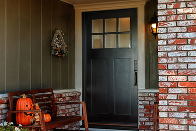 Mid-sized arts and crafts front door in Orange County with orange walls, a single front door and a black front door.