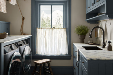 Example of a small cottage galley terra-cotta tile and gray floor laundry room design in Philadelphia with an undermount sink, shaker cabinets, blue cabinets, marble countertops, beige walls, a side-by-side washer/dryer and white countertops