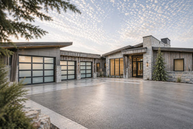 Garage - large modern three-car garage idea in Salt Lake City