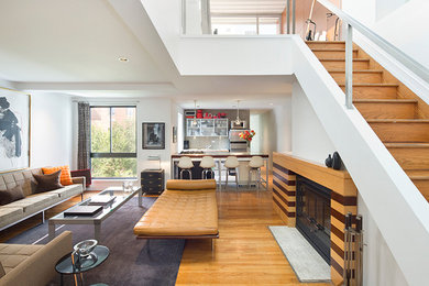 Small minimalist formal and loft-style light wood floor living room photo in New York with white walls, a standard fireplace, a wood fireplace surround and no tv