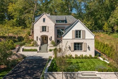Large traditional beige four-story brick exterior home idea in New York with a shingle roof and a gray roof