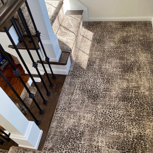Mittelgroße Klassische Holztreppe in U-Form mit Teppich-Setzstufen, Stahlgeländer und Holzwänden in Detroit