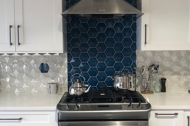 Trendy eat-in kitchen photo in Denver with an island and white countertops