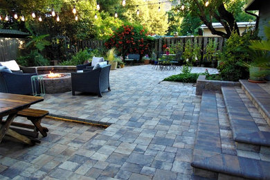 Inspiration for an arts and crafts backyard patio in San Francisco with a fire feature and concrete pavers.