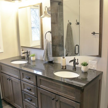 Moline, IL Bath Remodel With Gray Stained Cherry Vanity and Pebble Tiled Shower