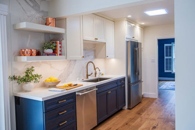 Small trendy galley medium tone wood floor and brown floor kitchen photo in San Francisco with an undermount sink, beaded inset cabinets, blue cabinets, quartz countertops, white backsplash, porcelain backsplash, stainless steel appliances, no island and white countertops
