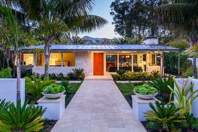 Photo of a midcentury one-storey exterior in Santa Barbara with a metal roof.