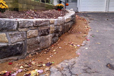 Design ideas for a mid-sized traditional full sun front yard retaining wall landscape in Boston.