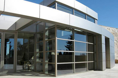 Large modern beige mixed siding flat roof idea in Calgary