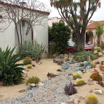 Dry streambed in a desert garden with Spanish style home