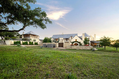 Example of a country white exterior home design in Austin with a shingle roof and a gray roof