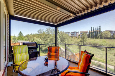 Photo of a modern balcony in Calgary with a pergola.