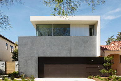 Photo of a contemporary two-storey concrete beige house exterior in Los Angeles with a flat roof.