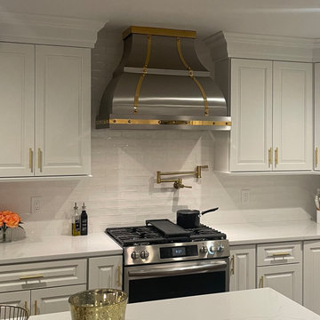 Elegant White Kitchen with a Custom Stainless Steel Hood
