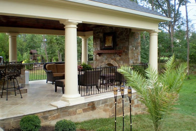 Example of a large classic backyard tile patio design in DC Metro with a fire pit and a roof extension