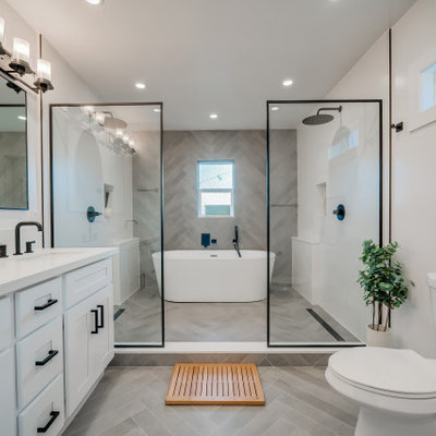 Example of a mid-sized trendy master gray tile and ceramic tile ceramic tile, gray floor and double-sink bathroom design in Los Angeles with shaker cabinets, white cabinets, a two-piece toilet, white walls, an undermount sink, quartz countertops, white countertops, a niche and a built-in vanity