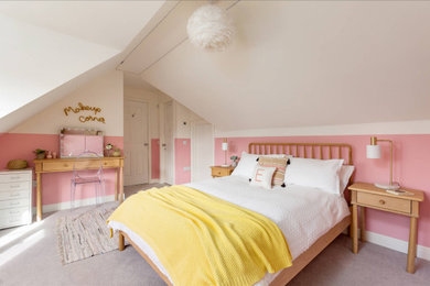 Inspiration for a medium sized contemporary teen’s room for girls in Other with pink walls, carpet, beige floors and a vaulted ceiling.