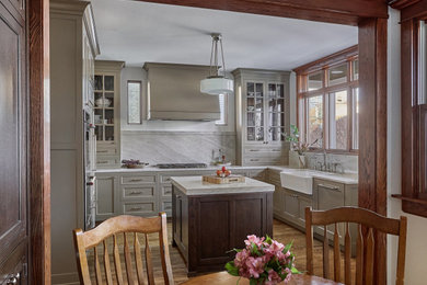 Kitchen - small transitional u-shaped dark wood floor kitchen idea in Chicago with a farmhouse sink, beaded inset cabinets, gray cabinets, quartz countertops, gray backsplash, marble backsplash, stainless steel appliances, an island and white countertops