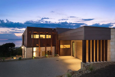 Photo of a large contemporary two-storey brown house exterior in Geelong with stone veneer and a flat roof.