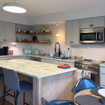 Curated Condo: Eclectic Kitchen, Light Wood Island, Veined Quartz