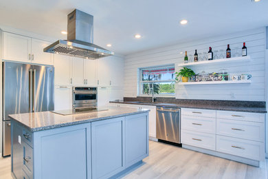 Small transitional l-shaped eat-in kitchen photo in Tampa with shaker cabinets, white cabinets, granite countertops, stainless steel appliances and an island