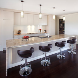 Kitchen pantry appliance - Galley kitchen pantry photo in Sydney with a drop-in sink, beige cabinets, marble countertops, beige backsplash, glass sheet backsplash, stainless steel appliances and an island