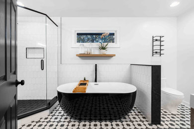 Mid-sized transitional master white tile and porcelain tile porcelain tile, multicolored floor and single-sink bathroom photo in Atlanta with flat-panel cabinets, light wood cabinets, white walls, an undermount sink, quartz countertops, white countertops and a freestanding vanity