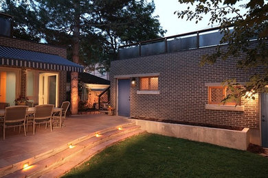 Inspiration for a mid-sized modern one-storey brick black exterior in Denver with a flat roof.