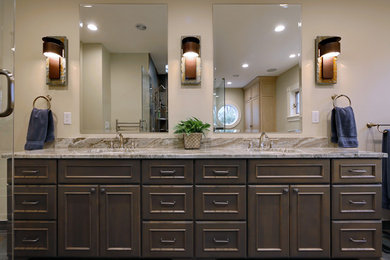 Inspiration for a large rustic master multicolored tile and porcelain tile porcelain tile bathroom remodel in Boston with furniture-like cabinets, distressed cabinets, a one-piece toilet, beige walls, an undermount sink and granite countertops