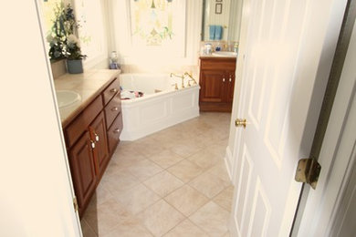 Inspiration for a mid-sized contemporary master gray tile and ceramic tile porcelain tile bathroom remodel in Other with an undermount sink, raised-panel cabinets, white cabinets, quartz countertops and a two-piece toilet