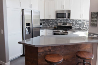 Eat-in kitchen - small contemporary u-shaped dark wood floor eat-in kitchen idea in Orange County with glass-front cabinets, white cabinets, quartz countertops, multicolored backsplash, glass tile backsplash, stainless steel appliances and a peninsula
