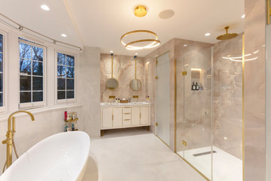 Inspiration for a large modern grey and pink ensuite bathroom in London with beaded cabinets, white cabinets, a freestanding bath, a built-in shower, a wall mounted toilet, pink tiles, porcelain tiles, pink walls, porcelain flooring, a built-in sink, marble worktops, beige floors, a hinged door, grey worktops, a wall niche, double sinks and a floating vanity unit.