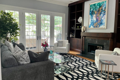 Living room - mid-sized modern open concept medium tone wood floor and brown floor living room idea in Other with gray walls, a standard fireplace and no tv
