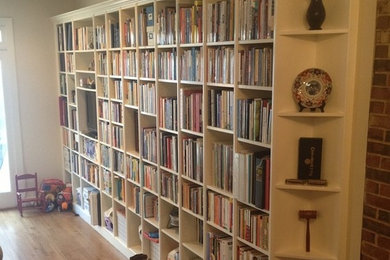 Mid-sized enclosed light wood floor living room library photo in DC Metro with beige walls, no fireplace and no tv