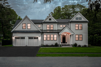 Large transitional white two-story concrete fiberboard and shingle house exterior photo in Boston with a mixed material roof and a black roof