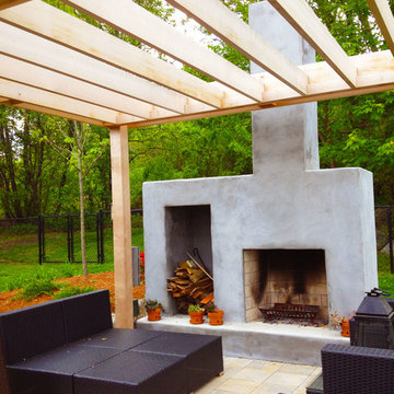 Outdoor entertaining area with custom fireplace and wood pergola