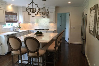 Eat-in kitchen - mid-sized transitional l-shaped dark wood floor eat-in kitchen idea in Other with an undermount sink, recessed-panel cabinets, white cabinets, granite countertops, white backsplash, stainless steel appliances and an island