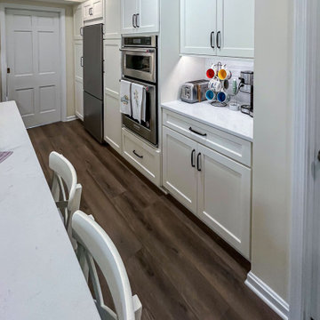 Custom Two-Toned Green and White Kitchen with Laventa Carrara Quartz Countertops